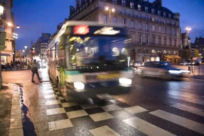 A city bus on one of the streets of Paris in the evening
