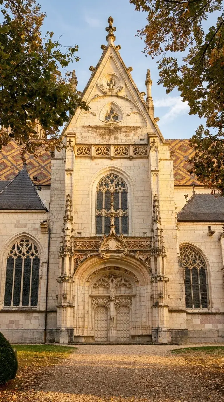 The facade of the Brou monastery church in Bourg-en-Bresse, with the glazed diamond-patterned roof on either side. Photo: Zvi Chazanov